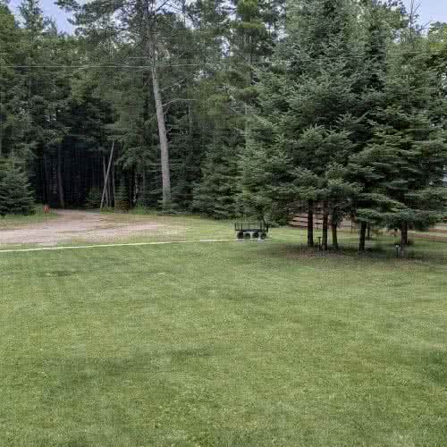 Ample free parking on premises at Smile Awhile in Eagle River, WI, with plenty of room for boat trailers, snowmobile haulers, and multiple vehicles.
