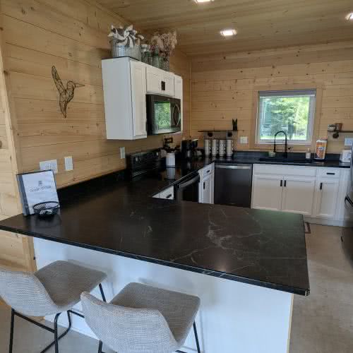 Large granite countertops and modern sink at Smile Awhile, providing plenty of space for preparing large family meals in Eagle River.